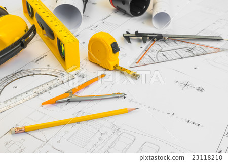 Construction plans with yellow helmet and drawing tools on blueprints . Construction plans with yellow helmet and drawing tools on blueprints . 23118210