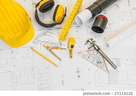 Construction plans with yellow helmet and drawing tools on blueprints . Construction plans with yellow helmet and drawing tools on blueprints . 23118228