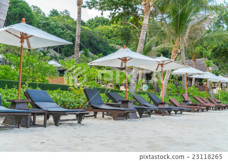 Beautiful beach chairs with umbrella on tropical white sand beach 23118265