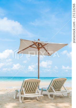 Beautiful beach chairs with umbrella on tropical white sand beach 23118266
