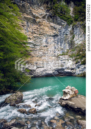 small mountain lake with green surface at the rock 23124022