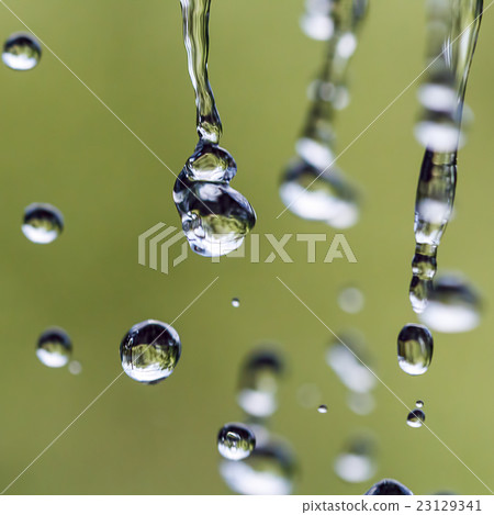 Raindrops on a rope for clothes on a blurred backg 23129341