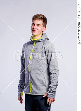 Boy in gray sports jacket, young man, studio shot 23131684