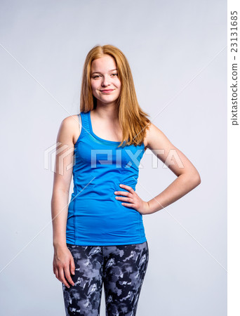 Girl in blue singlet and fitness leggings, young Girl in blue singlet and fitness leggings, young 23131685