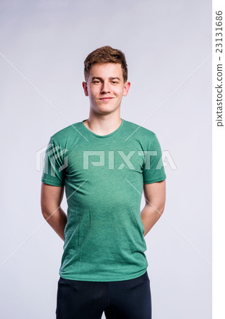 Boy in black sports trousers and t-shirt, studio 23131686