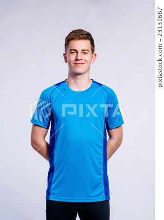 Boy in blue sports t-shirt, young man, studio shot Boy in blue sports t-shirt, young man, studio shot 23131687