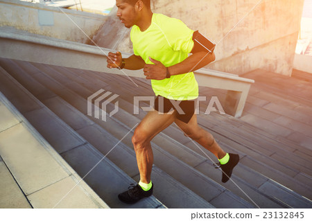 Male dark-skinned athlete running up  23132845