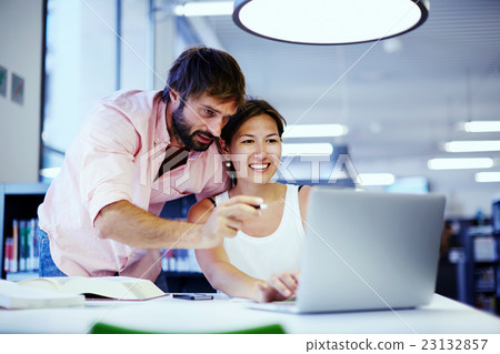 Students talking together over computer Students talking together over computer 23132857
