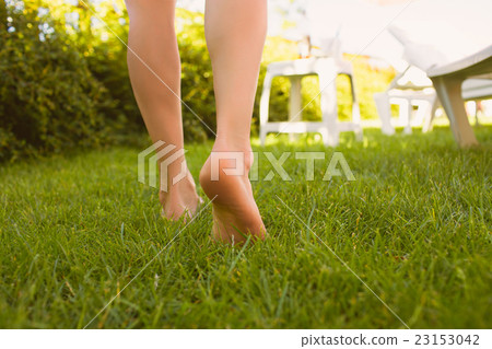Close up female legs walking on the grass. Close up female legs walking on the grass. 23153042