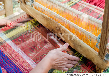 Weaving on a wooden loom Weaving on a wooden loom 23153116