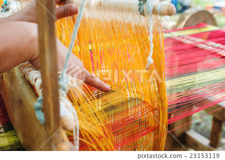 Weaving on a wooden loom 23153119
