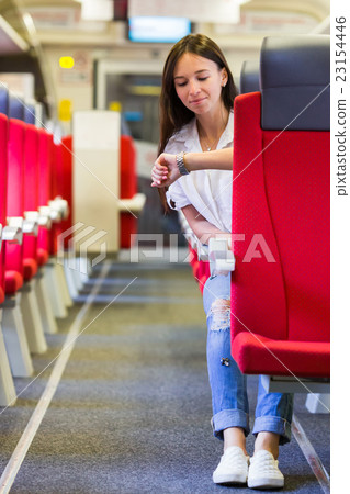 Young happy girl looking at watch traveling by Young happy girl looking at watch traveling by 23154446
