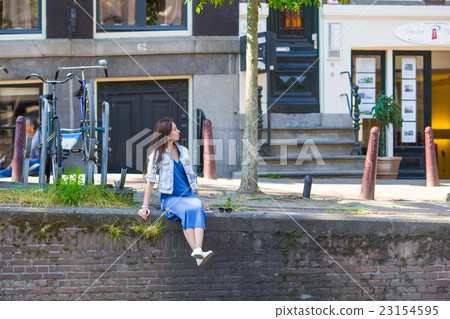 Young beautiful woman walking in european city Young beautiful woman walking in european city 23154595