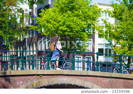 Young beautiful woman walking in european city Young beautiful woman walking in european city 23154596