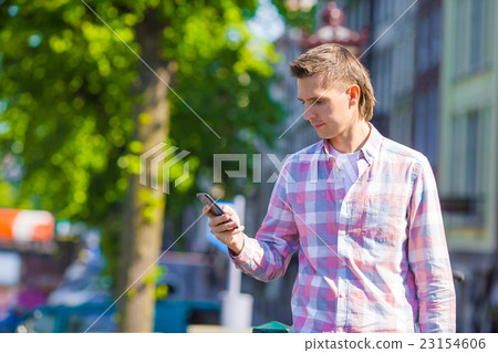 Young caucasian man with cell phone in european Young caucasian man with cell phone in european 23154606