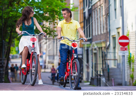 Young happy couple on bikes in old streets in Young happy couple on bikes in old streets in 23154633