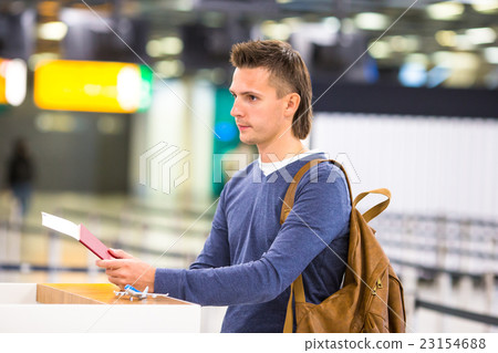 Young man with passports and boarding passes at Young man with passports and boarding passes at 23154688