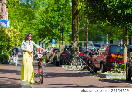 Young happy woman on bike in european city Young happy woman on bike in european city 23154709