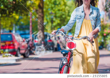 Young happy woman on bike in european city Young happy woman on bike in european city 23155805