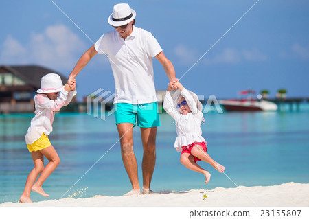 Happy beautiful family on a tropical beach Happy beautiful family on a tropical beach 23155807