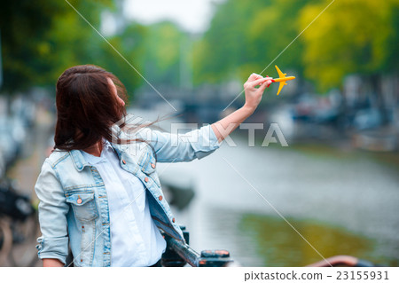 Woman with airplane model background of canal in Woman with airplane model background of canal in 23155931