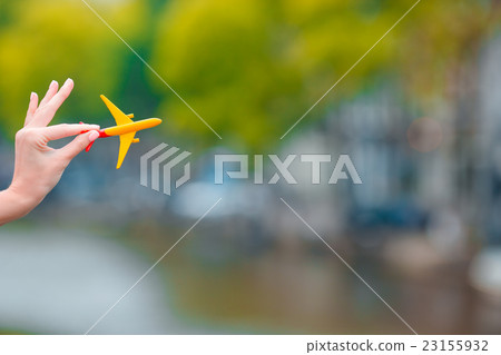Little white airplane model in female hand Little white airplane model in female hand 23155932