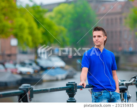 Young happy man listening to music background of Young happy man listening to music background of 23155935