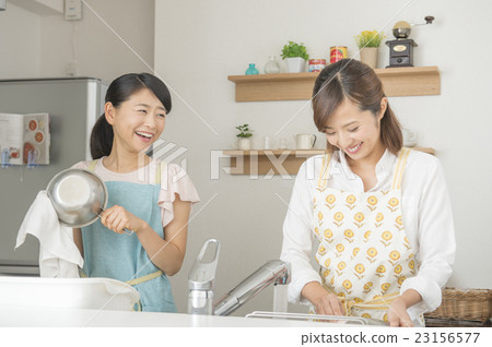 Two women standing in the kitchen 23156577