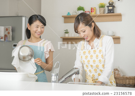 Two women standing in the kitchen Two women standing in the kitchen 23156578