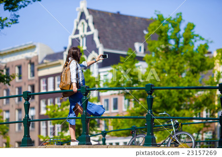 Young woman taking self portrait in european city Young woman taking self portrait in european city 23157269