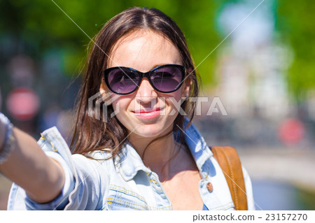 Young woman taking self portrait in european city Young woman taking self portrait in european city 23157270