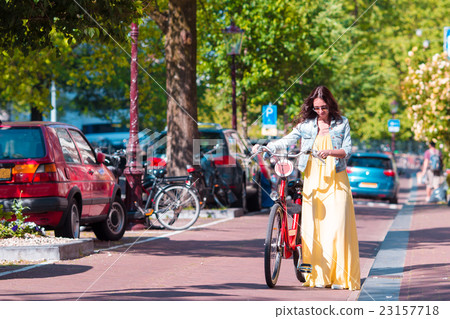 Young woman with bike on european vacation at Young woman with bike on european vacation at 23157718