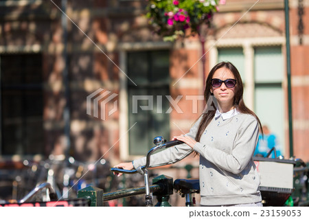 Young woman with bike on european vacation at Young woman with bike on european vacation at 23159053
