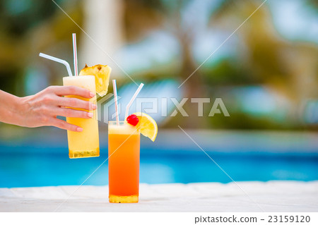 Two tasty cocktails on tropical white beach 23159120