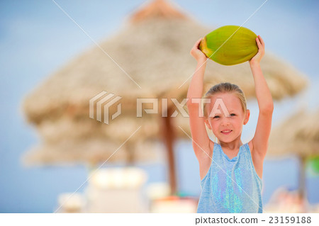 Little adorable girl with coconut on white Little adorable girl with coconut on white 23159188
