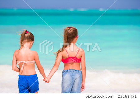 Adorable little girls at beach during summer Adorable little girls at beach during summer 23162451