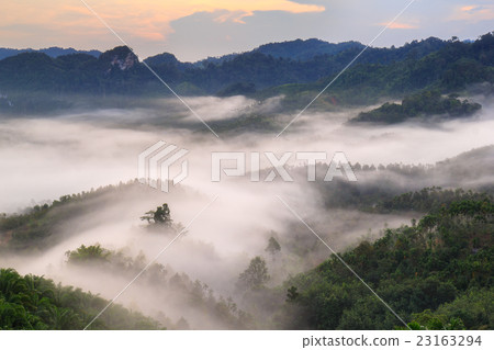 Layer of mountains and mist at sunset time Layer of mountains and mist at sunset time 23163294