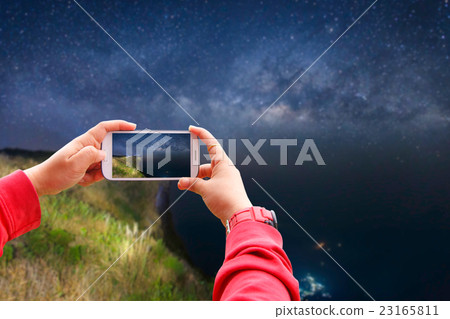 Smartphone photographing milky way galaxy  23165811