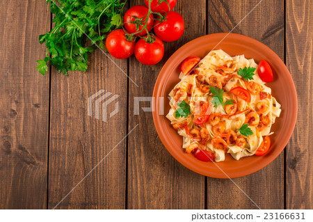Fettuccine pasta with shrimp tomatoes and herbs. 23166631