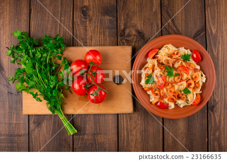 Fettuccine pasta with shrimp tomatoes and herbs. 23166635
