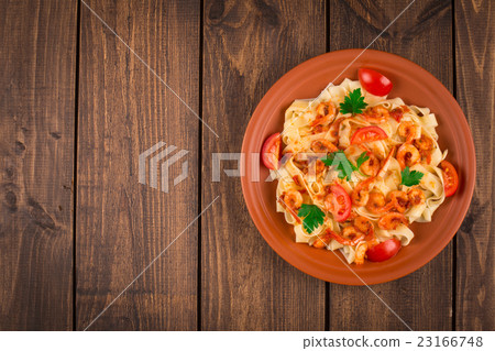 Fettuccine pasta with shrimp tomatoes and herbs. 23166748