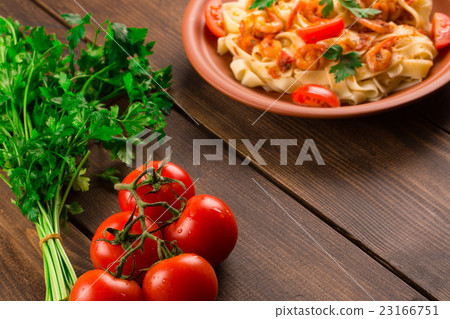 Fettuccine pasta with shrimp tomatoes and herbs. Fettuccine pasta with shrimp tomatoes and herbs. 23166751
