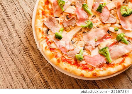pizza on wooden background 23167284