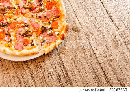 pizza on wooden background 23167285
