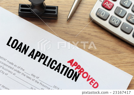 Approved loan application with rubber stamp  23167417