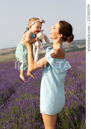 Young mom with child girl in lavender field Young mom with child girl in lavender field 23169204