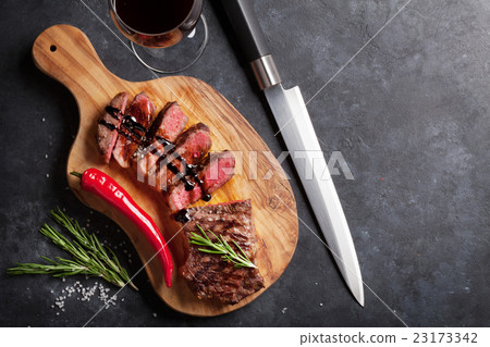 Grilled striploin steak and red wine Grilled striploin steak and red wine 23173342