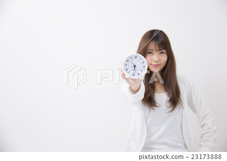 Woman wearing alarm clock and room wearing white back Woman wearing alarm clock and room wearing white back 23173888