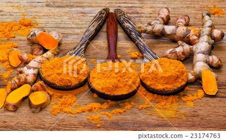 fresh turmeric roots on wooden table 23174763