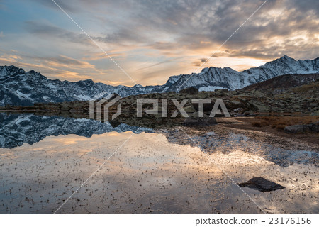 High altitude alpine lake, reflections at sunset High altitude alpine lake, reflections at sunset 23176156